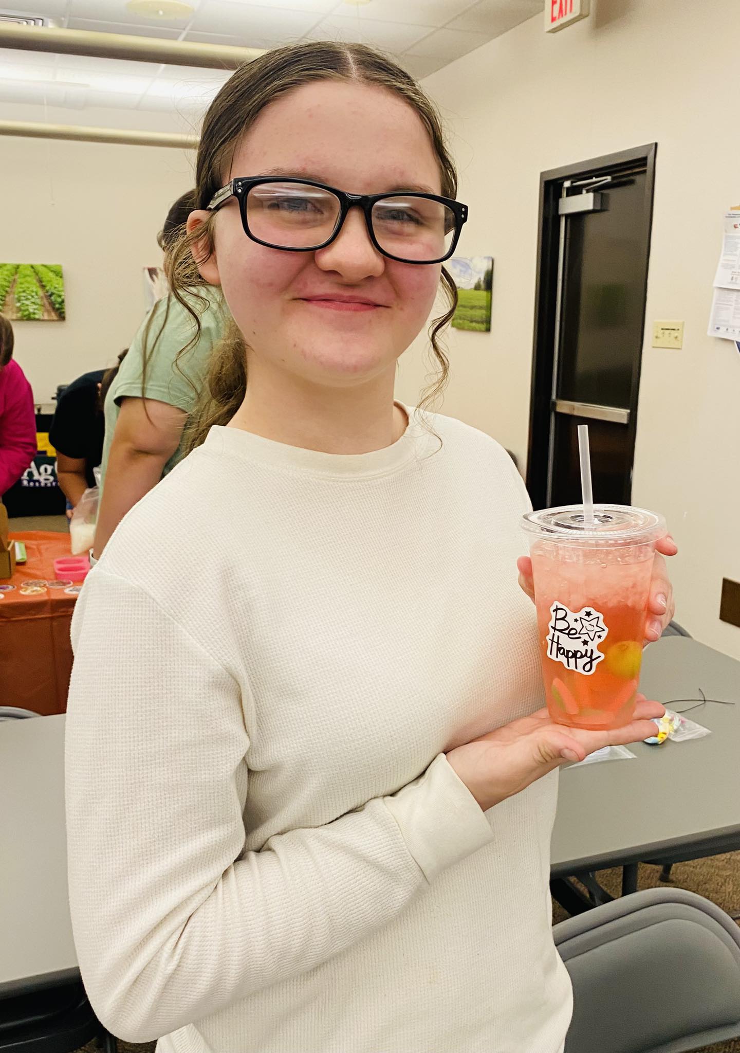 A girl holding a drink.